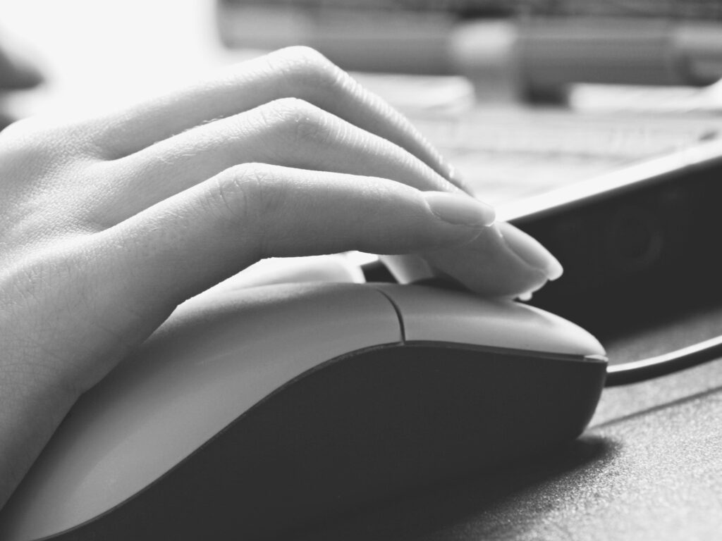 human hands touching computer mouse and keys
